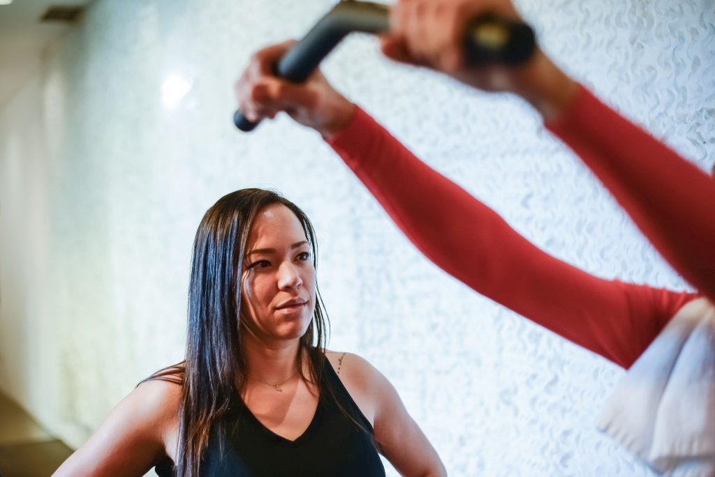 Two women training together with weights