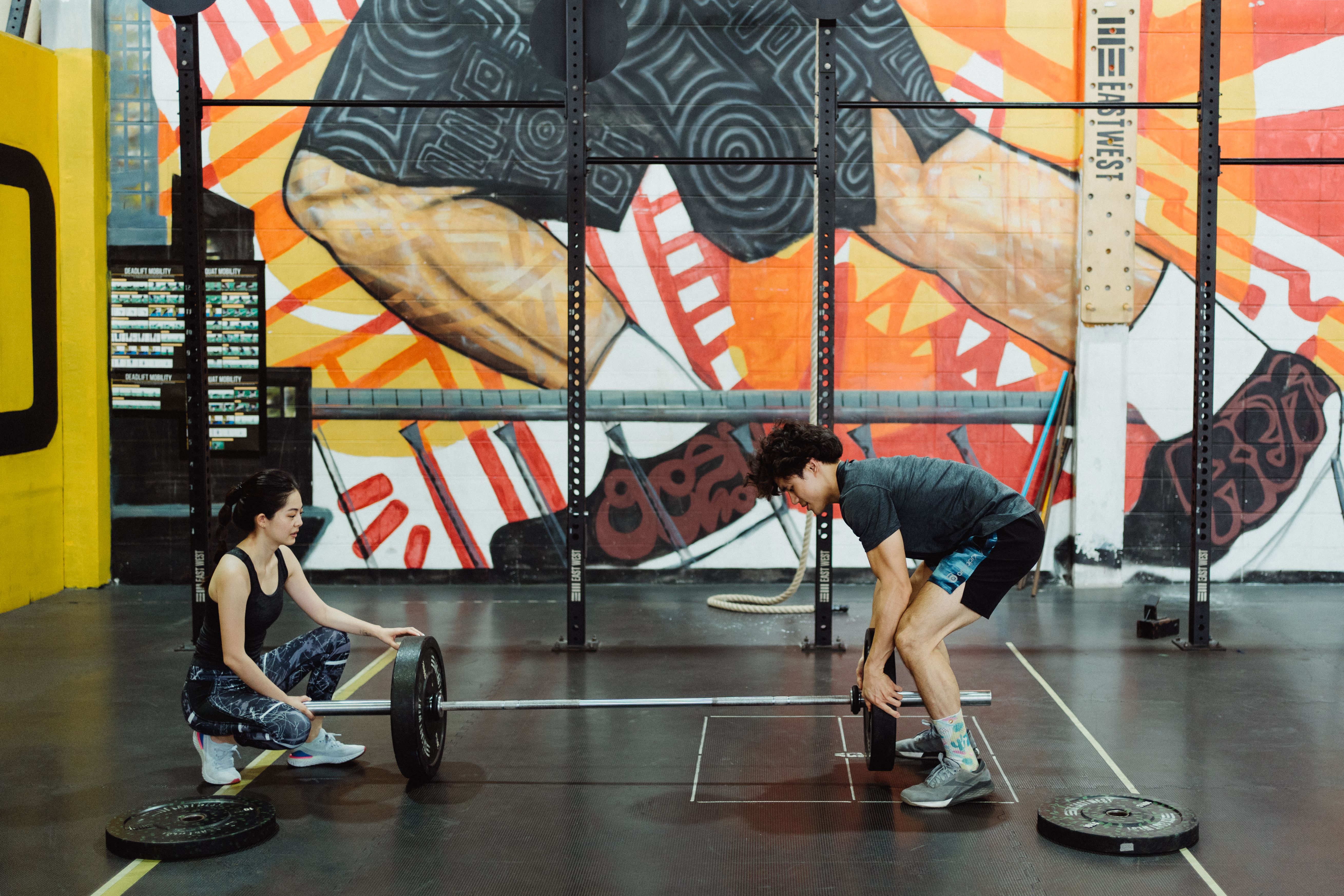 Female trainer guiding resistance band training
