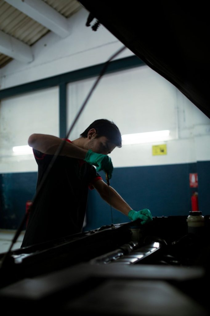 Nexolume Car Oil Change & Maintenance mechanic checking car oil