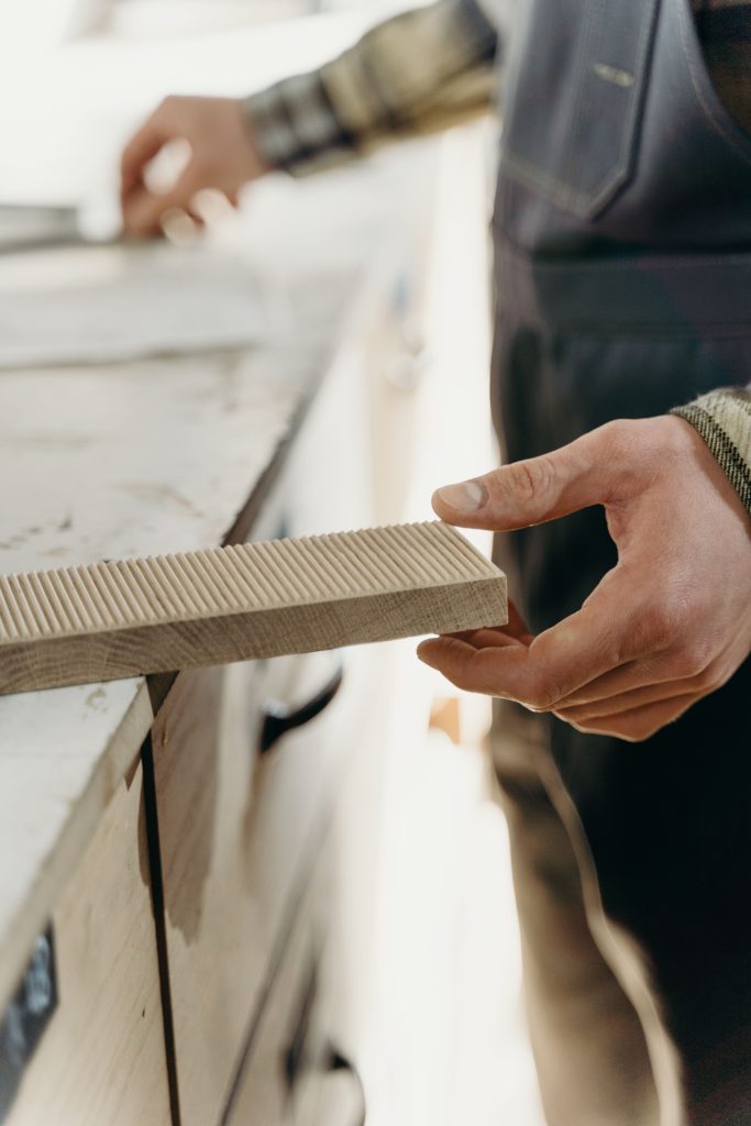 Carpenter measuring and crafting timber
