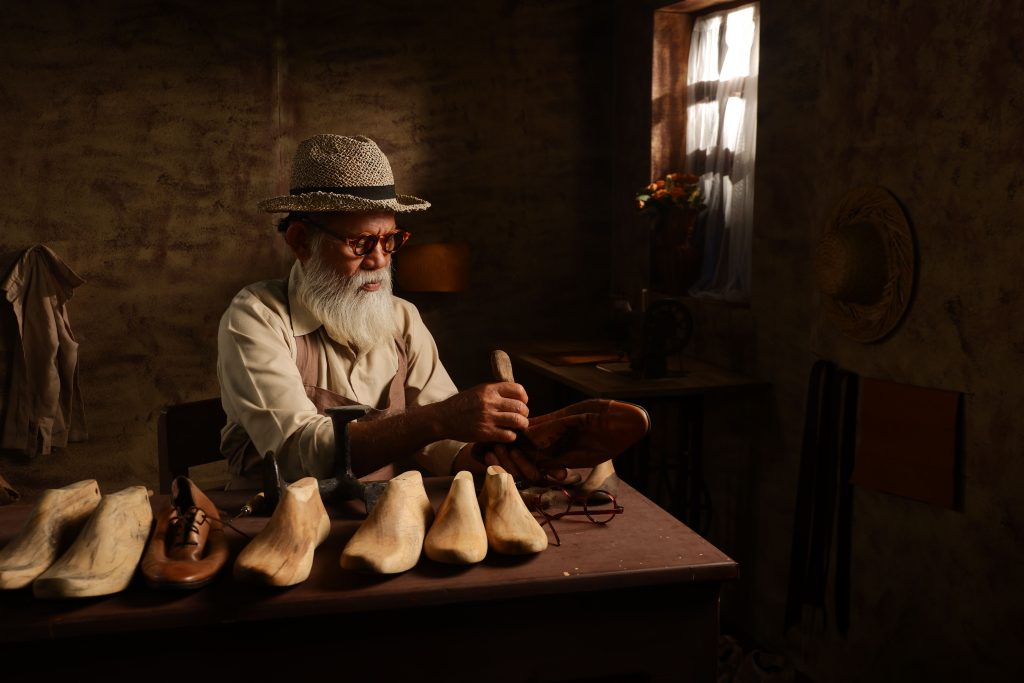 Cobbler repairing leather shoes