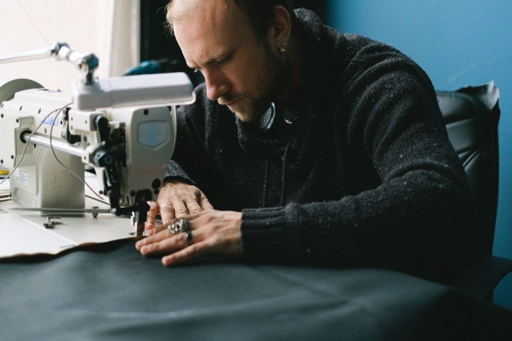 Nexolume Tailor Master & Bespoke Clothing tailor sewing on sewing machine