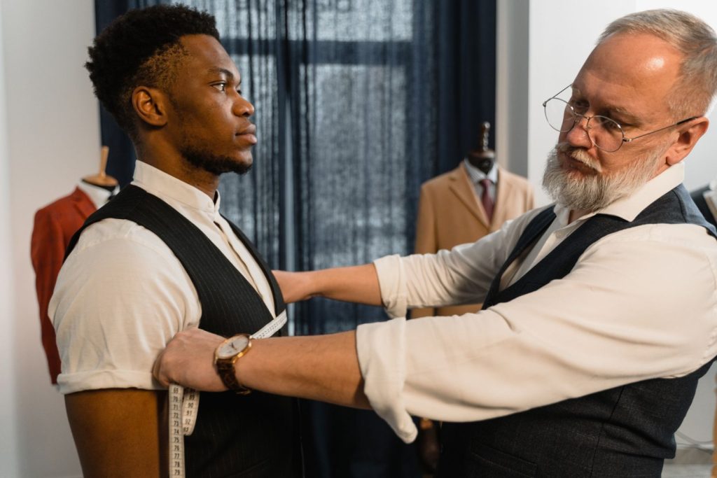 Nexolume Tailor Master & Bespoke Clothing tailor measuring a client for bespoke suit