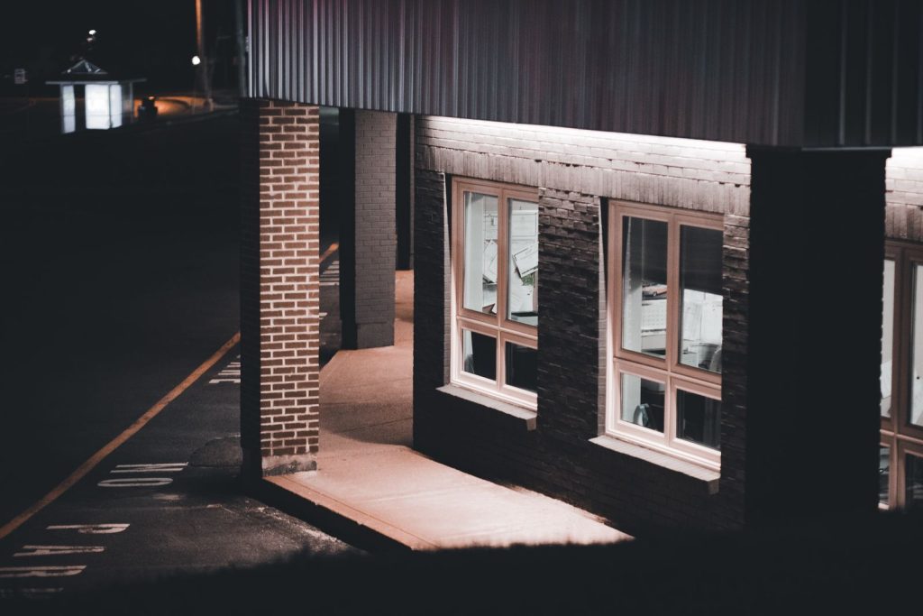 A dimly lit building facade at night with street view, showcasing urban architecture.
