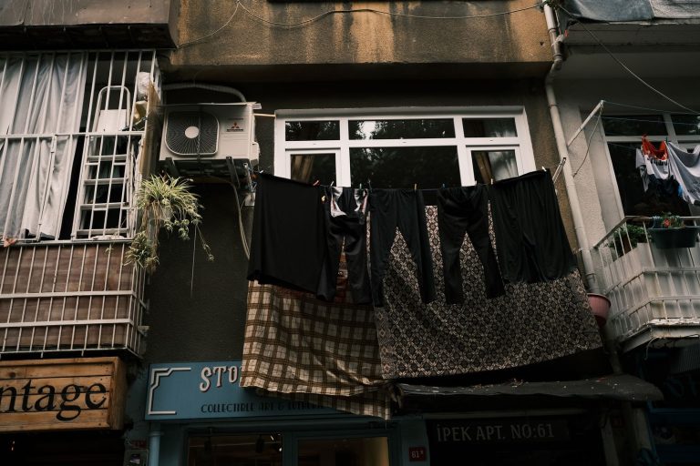 Laundry hanging outside an urban apartment, showcasing everyday city life.