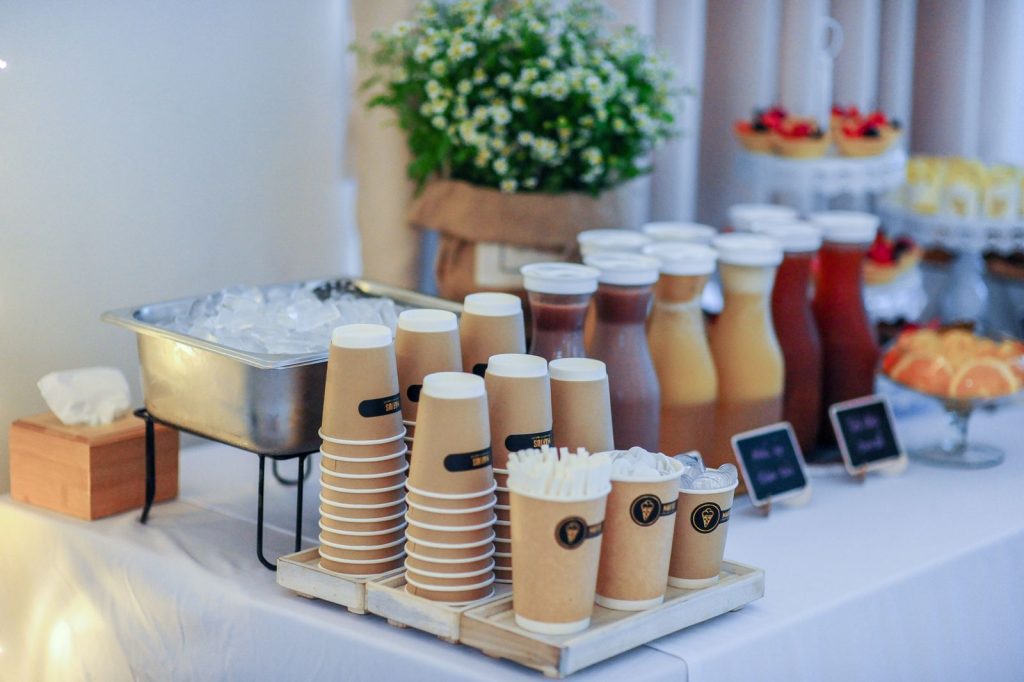 Stylish beverage station featuring various drinks and cups for an event, ideal for gatherings.
