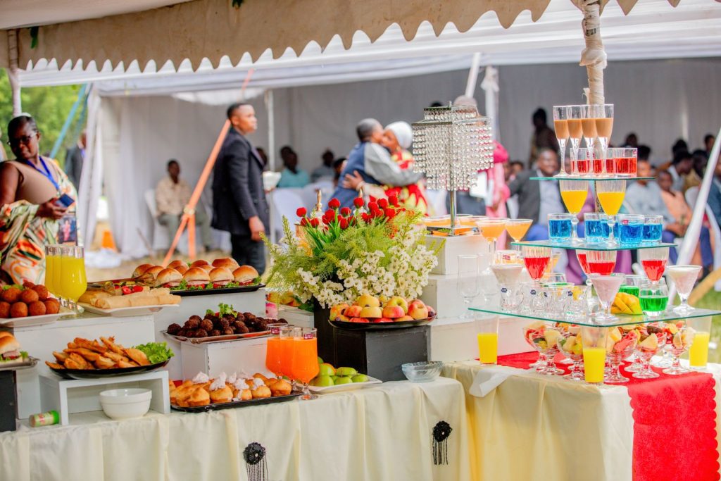 Colorful buffet arrangement with food and drink display at an outdoor gathering.