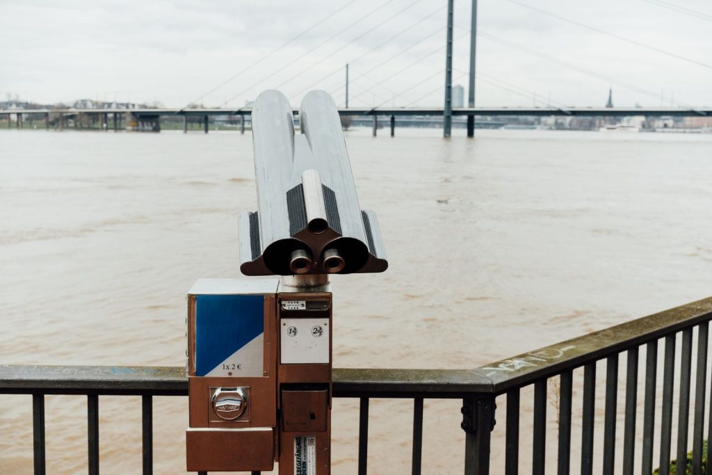 Explore the Rhine River view with a coin-operated telescope in Düsseldorf, Germany.