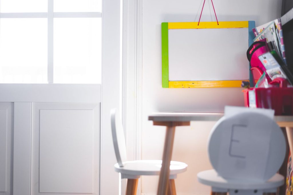A vibrant, well-lit children's study corner with a colorful board and chair, perfect for learning.