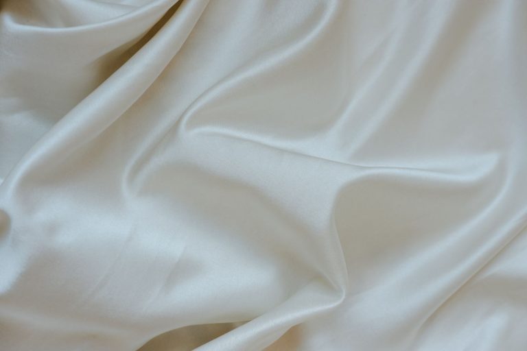 Elegant and soft white silk fabric texture, perfect for background and textile design.
