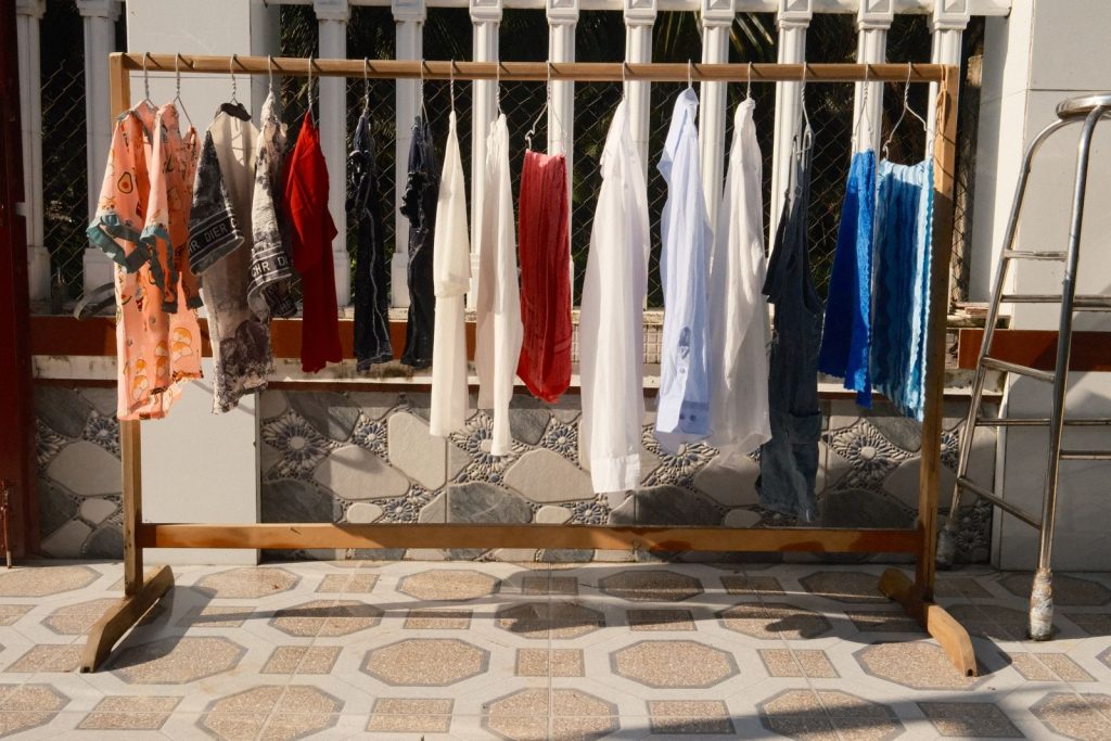 A variety of colorful clothes hanging to dry in the sunlight of Bến Tre, Vietnam.
