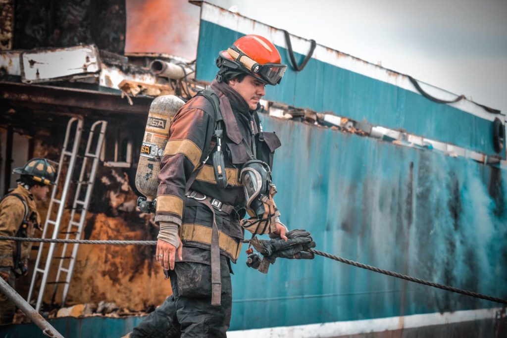 Firefighters in action extinguishing a ship fire in Guayaquil, Ecuador, showcasing bravery and teamwork.