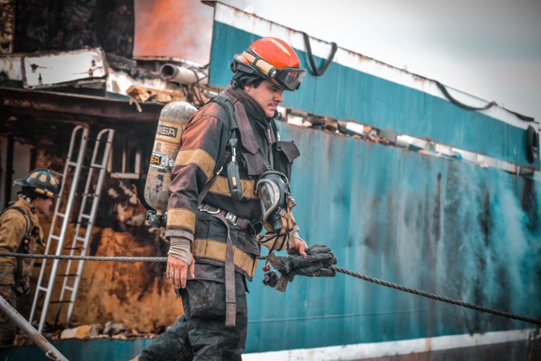 Firefighters in action extinguishing a ship fire in Guayaquil, Ecuador, showcasing bravery and teamwork.