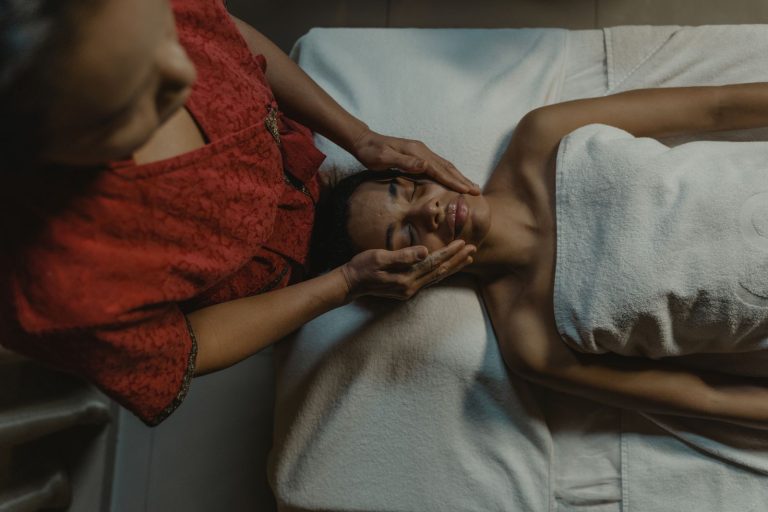 A woman enjoying a relaxing massage therapy session at a spa, promoting wellness and relaxation.