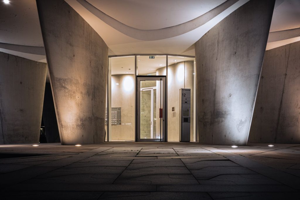 Modern architecture with illuminated entrance in Hamburg, showcasing futuristic design elements.