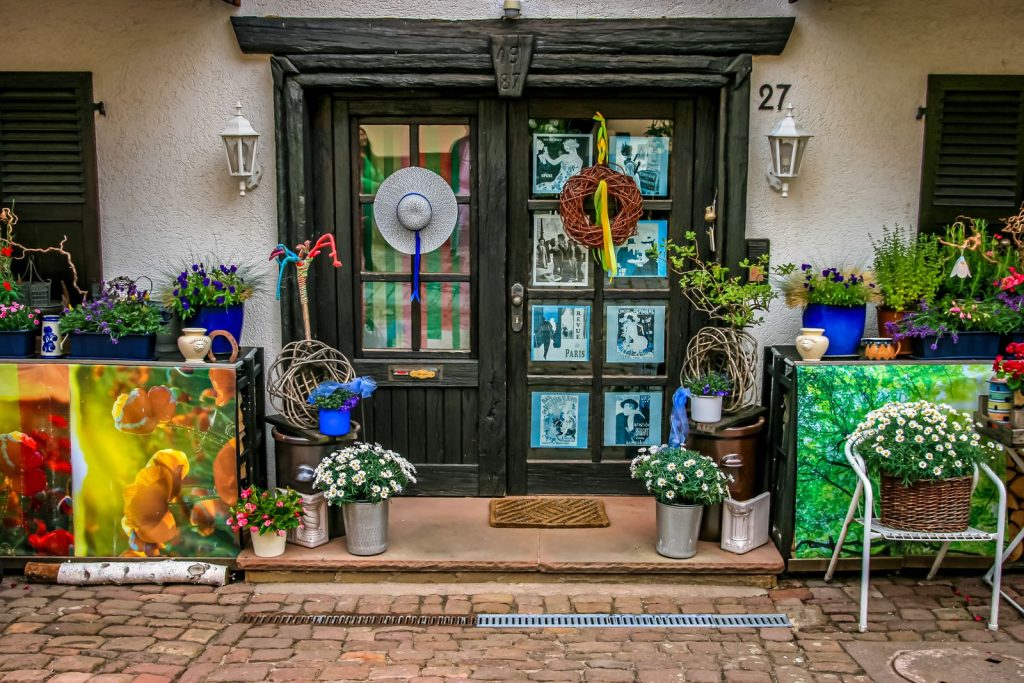 A colorful and charming entrance adorned with flowers and decorative elements.