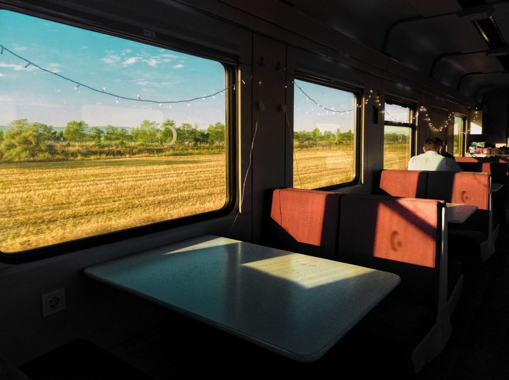 Interior train view with countryside scenery in Konya, Türkiye, showcasing rural travel experience.