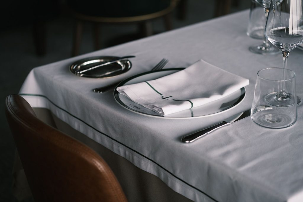 Stylish table setting in a restaurant with glassware and cutlery.
