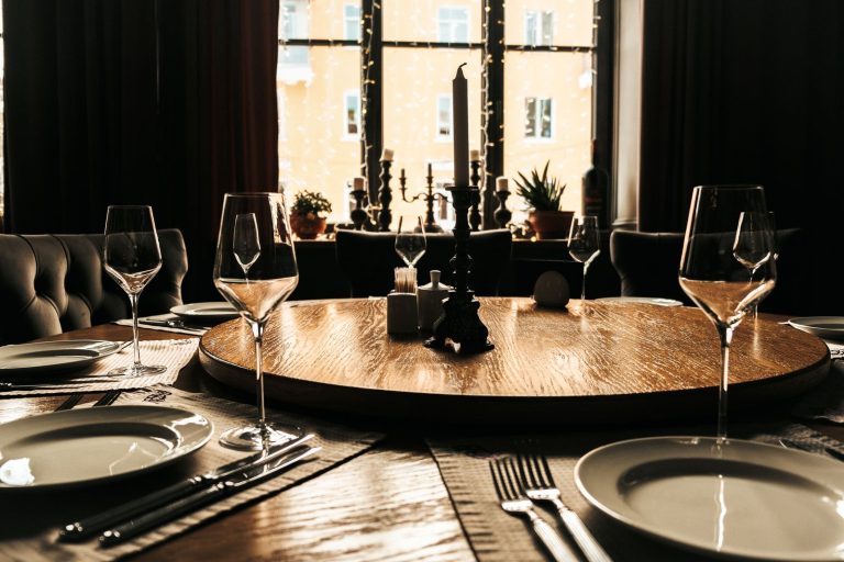 A beautifully set dining table with a candlelit ambiance, perfect for elegant gatherings.