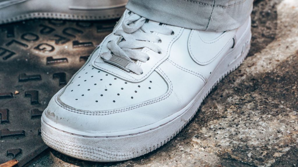 Detailed view of a white sneaker, showcasing urban street style and casual fashion.