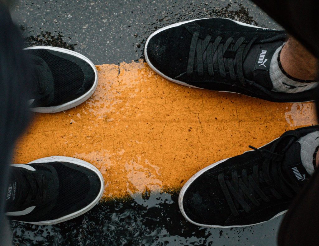 Close-up of sneakers on a wet street in São Paulo. Street style and sneaker culture.