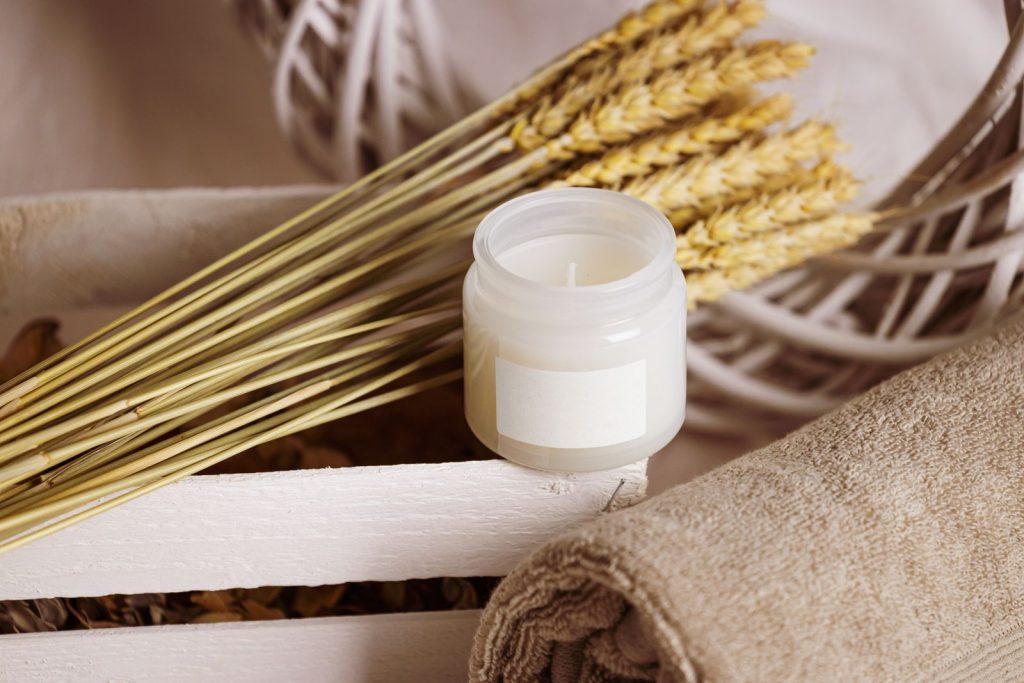 Elegant still life of a candle and towels in a spa setting, perfect for relaxation themes.