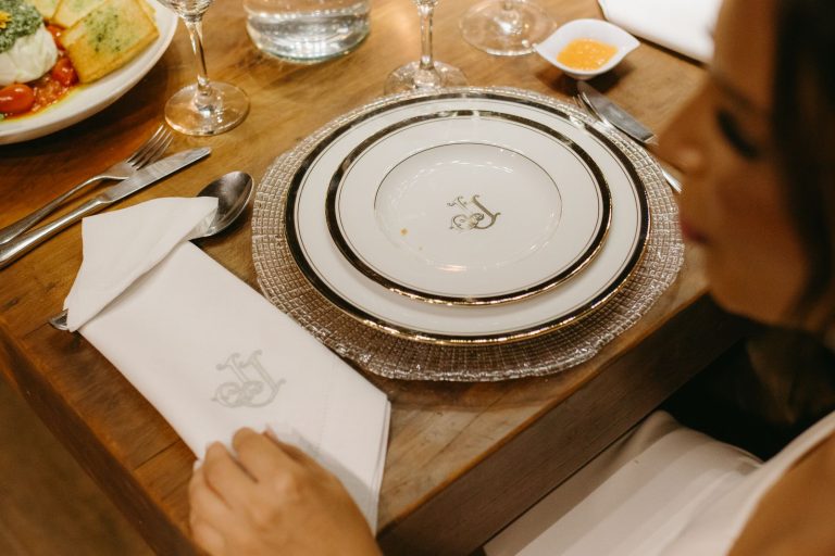 Elegant table setting with plated dishes, cutlery, and napkin for a formal dining experience.