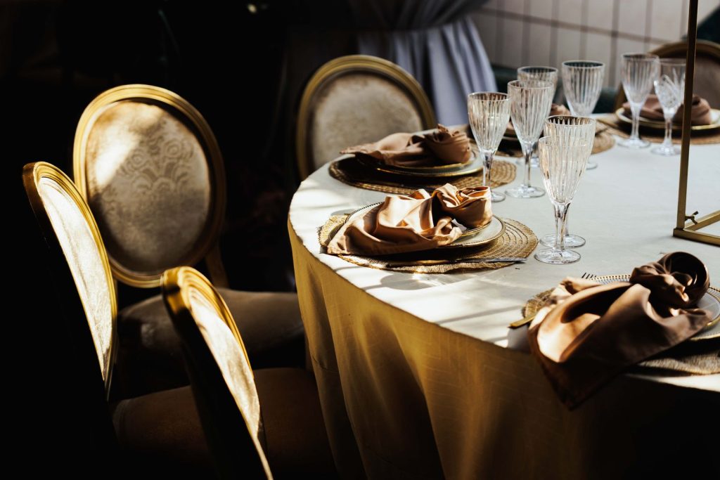 Sophisticated wedding table setup featuring luxurious chairs and crystal glassware.