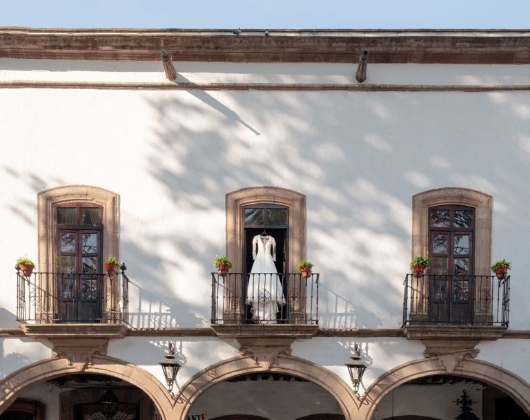 A beautiful wedding dress displayed on a classic balcony in Pátzcuaro, Mexico.