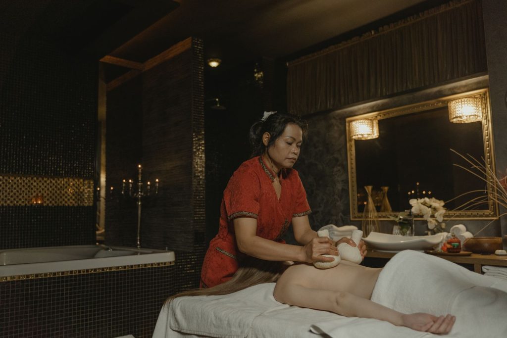 A skilled massage therapist performing a relaxing massage in a calming spa environment.