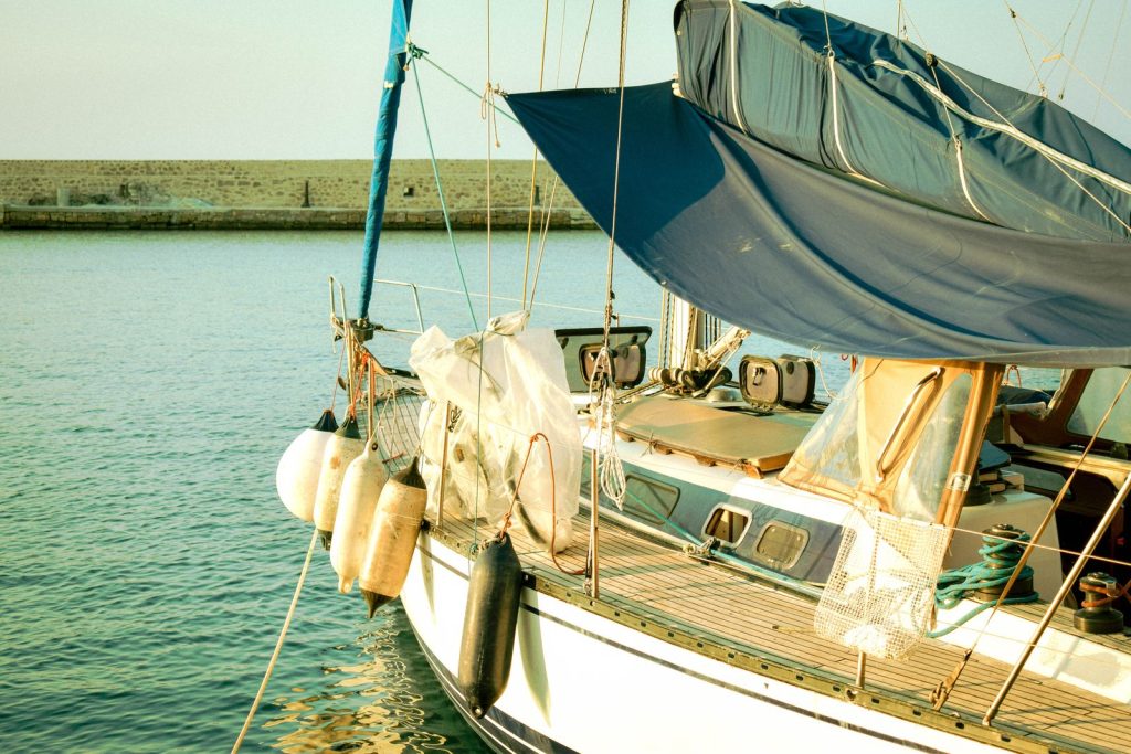 A serene view of a yacht moored in the picturesque harbor of Χανιά, Greece.