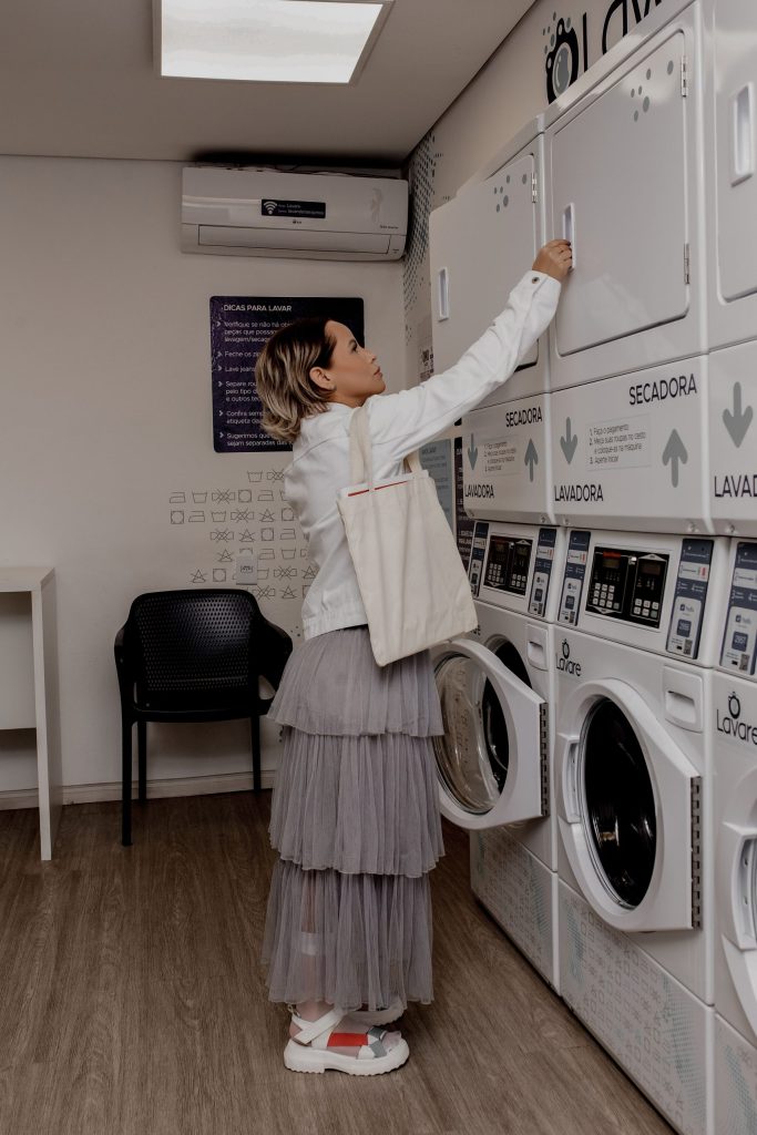 Customer using modern self service laundry machines