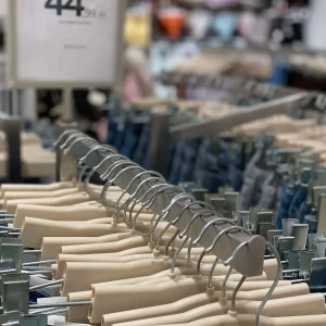 Clothes in hangers hanging on racks