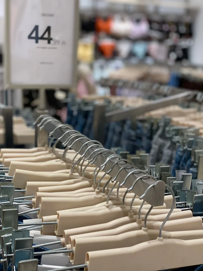 Clothes in hangers hanging on racks