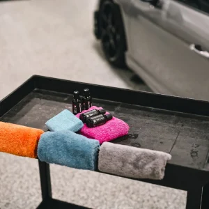 Colorful cloths on table near car