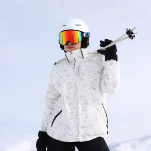 Ski enthusiast in white jacket on snowy slope