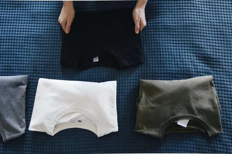 A person folding t shirts neatly