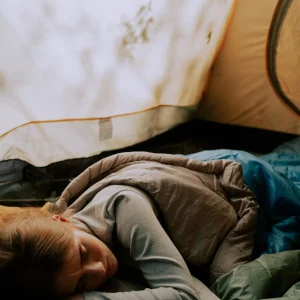 Photo of a woman sleeping in a tent