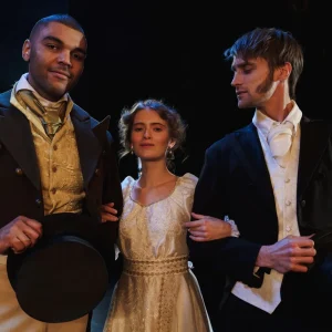 Two men and woman wearing different costumes