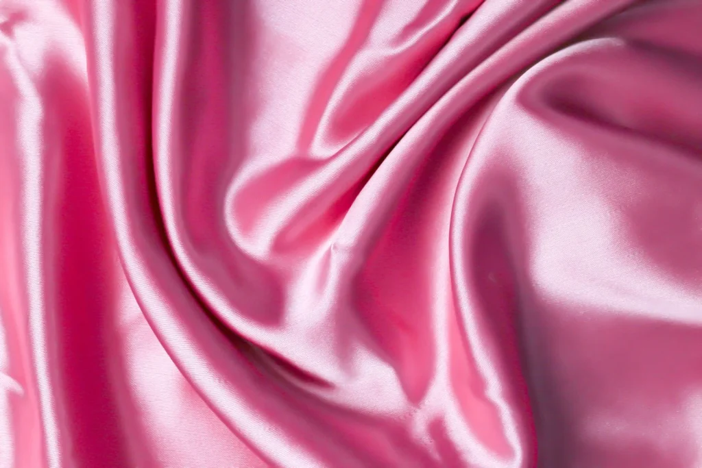 A close up shot of a pink satin fabric