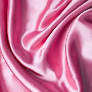 A close up shot of a pink satin fabric
