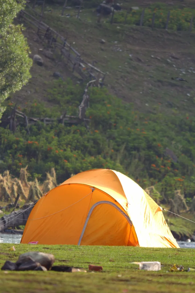 Bright orange tent in picturesque outdoor setting